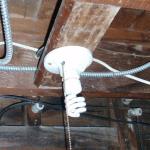 This porcelien base light fixture should not be mounted directly to a combustible framing member. There are 120 volt connections on the base which could become loose and arc/cause a fire. It should have been mounted on a box.