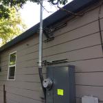 This service mast had to be supported by some metal brackets because the house was built without eaves. Sometimes you have to get creative. Why would anyone build a home without eaves? They provide great shade inside the house!